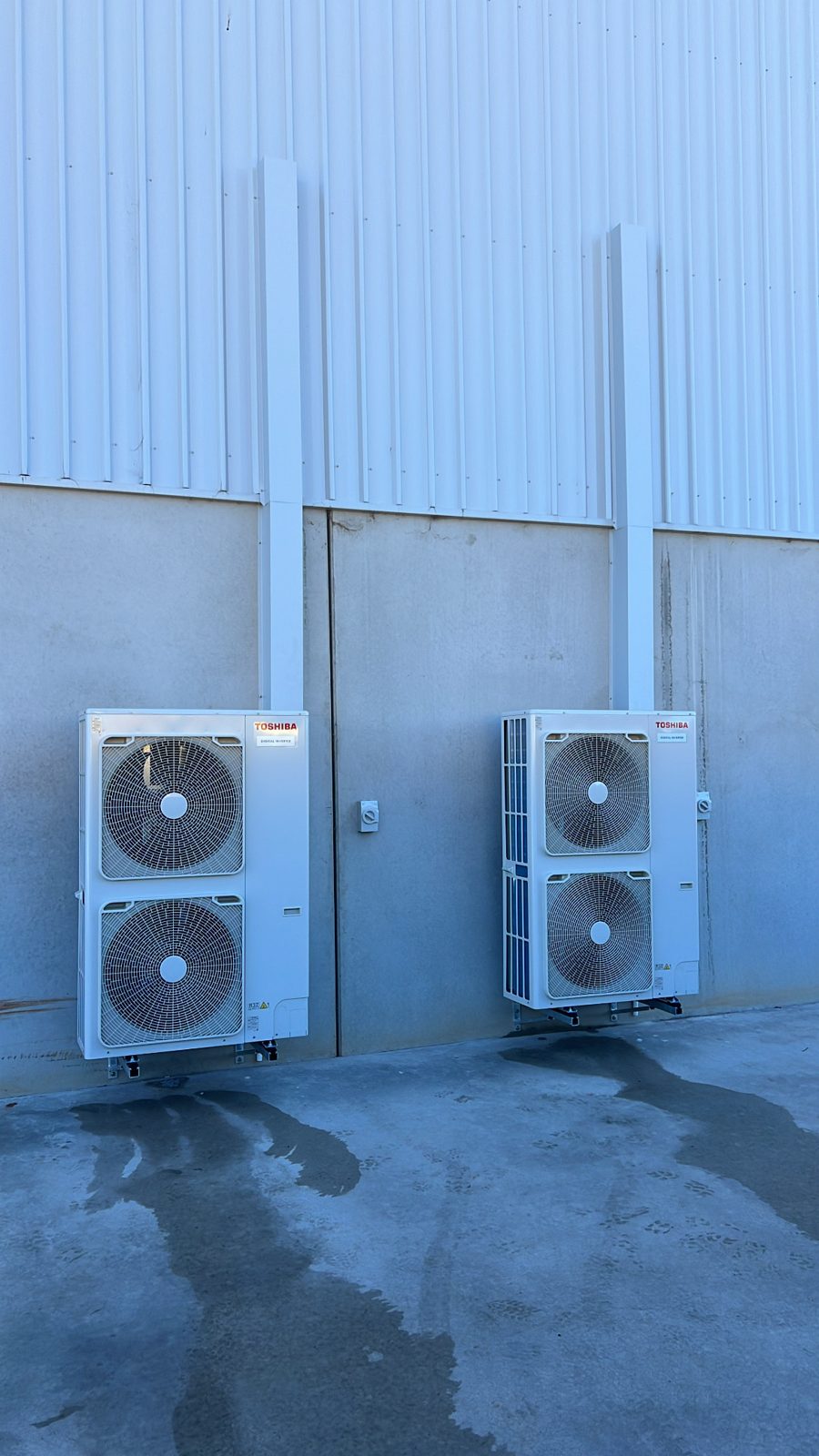 Twin condenser units installed at a Griffith property